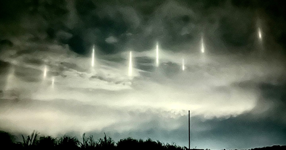 9 pillars of light appear in night sky above coastal Japanese town